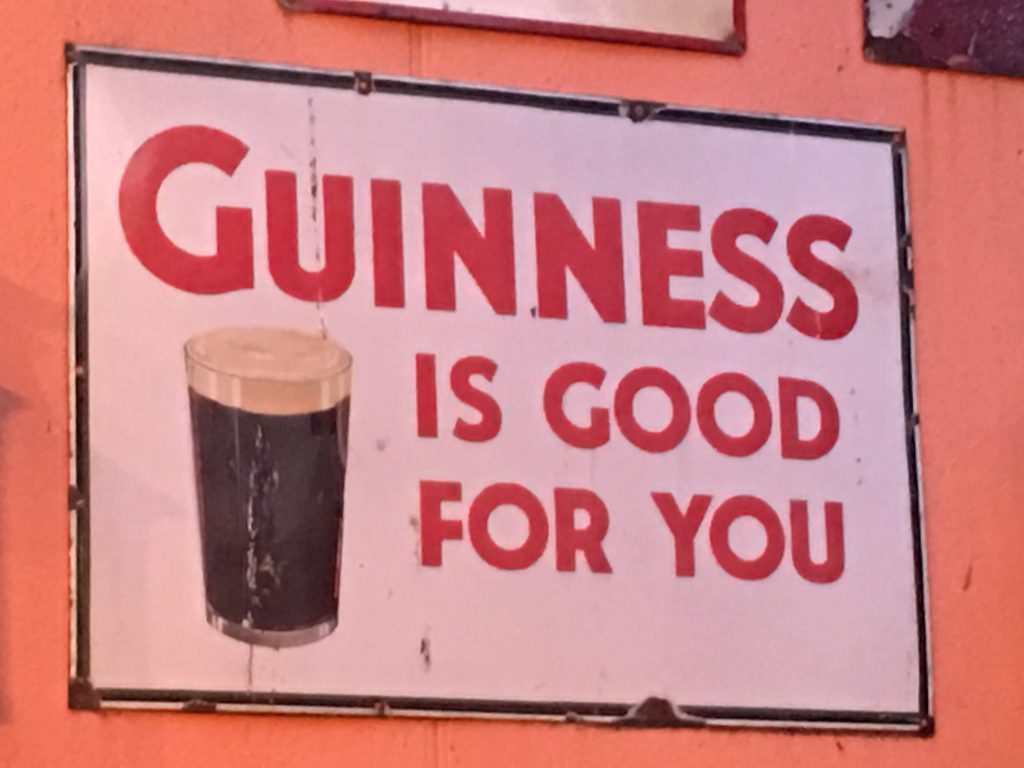 Image location: A pub in Dublin, Ireland. Image description: A sign which says 'Guinness is good for you'.