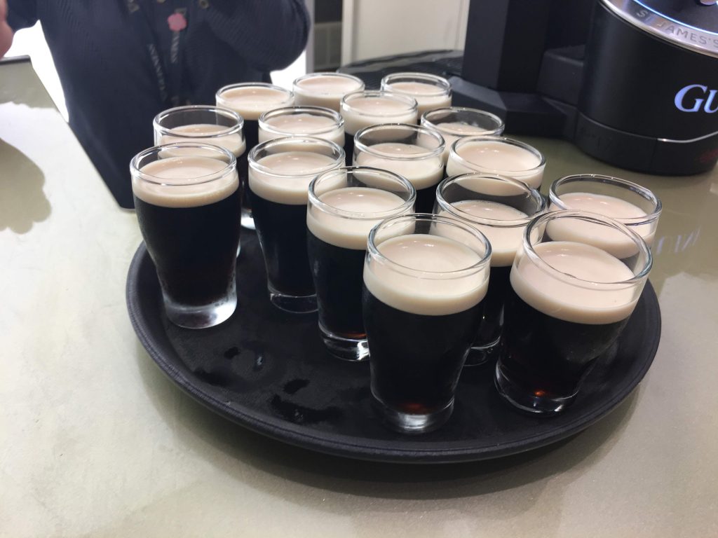 Image location: Guinness Storehouse, Dublin, Ireland. Image description: A tray of half pints of Guinness are ready to be served.